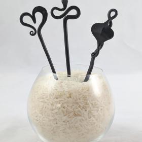 three hairpins in a clear container of rice