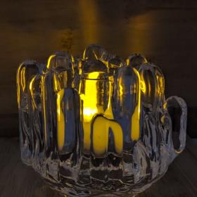 Polar crystal votive with a lit tealight in a dark room to create a serene ambiance. 