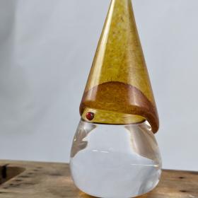 glass tomte with a clear body and red nose, amber colored hat. 