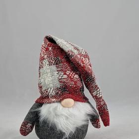 Plushie tomte with a plaid hat featuring colors of red and white. 