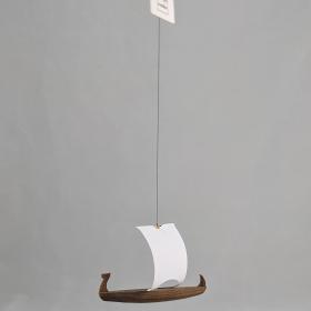Small wooden ship mobile with a white sail. 