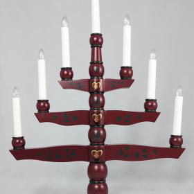 Burgundy candelabra with 7 lights, on 3 branches and one light on each side. Each branch gets smaller as it reaches the top, resembling a tree. 